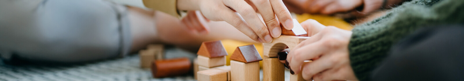 close-up of hands playing with blocks